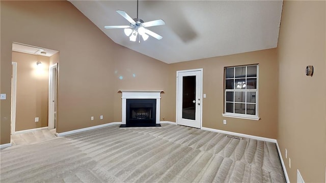 unfurnished living room featuring ceiling fan, high vaulted ceiling, and light colored carpet