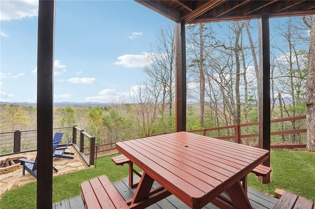 wooden deck with a lawn