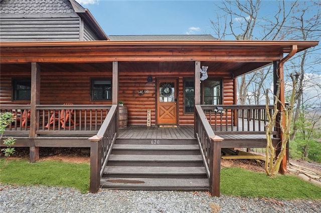 view of exterior entry featuring a porch