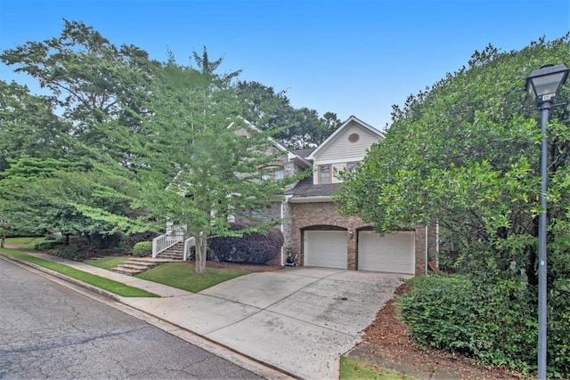 view of property hidden behind natural elements with a garage