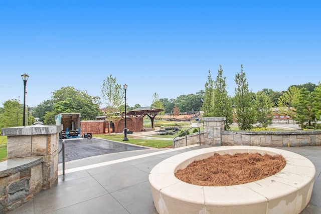 view of home's community with an outdoor fire pit