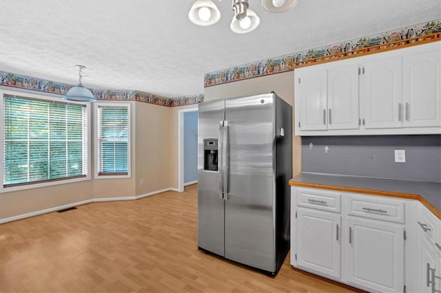 1341 Little Deer Run, Canton, GA 30114 - kitchen featuring stainless steel fridge, a textured ceiling, light wood-style flooring, white cabinetry, and dark countertops