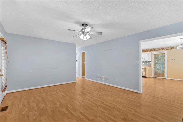 1341 Little Deer Run, Canton, GA 30114 - empty room featuring light wood finished floors, ceiling fan, and a textured ceiling