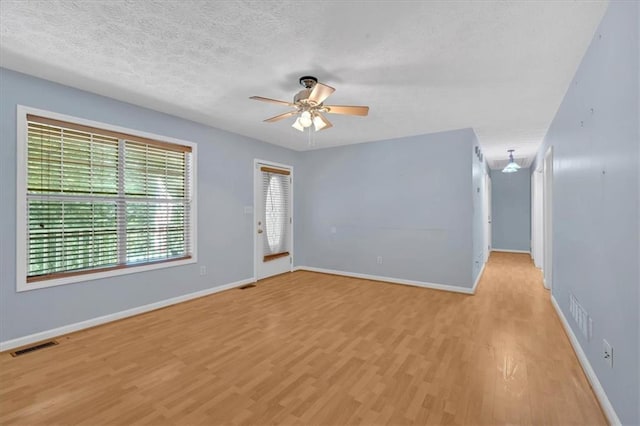1341 Little Deer Run, Canton, GA 30114 - empty room featuring a ceiling fan, light wood finished floors, and a textured ceiling