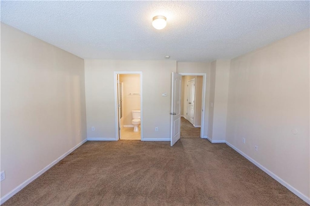 1830 Bayrose Cir Unit 30B, East Point, GA 30344 - unfurnished bedroom featuring a textured ceiling, connected bathroom, carpet floors, and baseboards