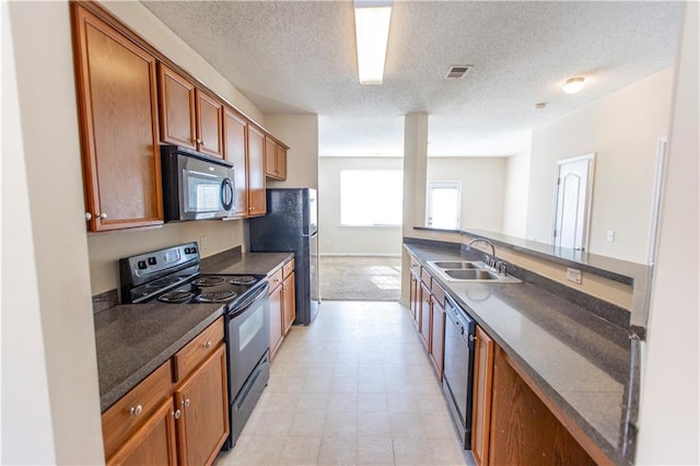 1830 Bayrose Cir Unit 30B, East Point, GA 30344 - kitchen featuring a sink, brown cabinetry, a textured ceiling, black appliances, and dark countertops