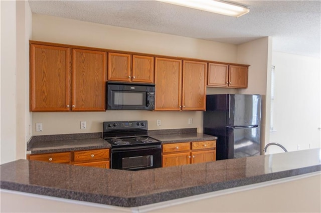 1830 Bayrose Cir Unit 30B, East Point, GA 30344 - kitchen featuring a sink, a textured ceiling, black appliances, and brown cabinets