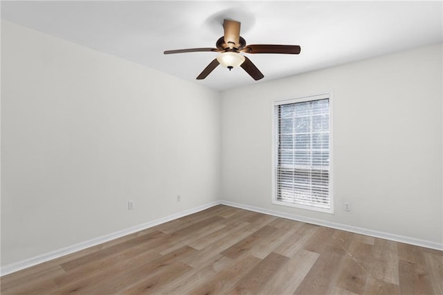 unfurnished room with ceiling fan, baseboards, and wood finished floors