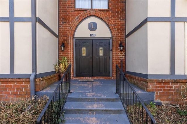 property entrance featuring brick siding