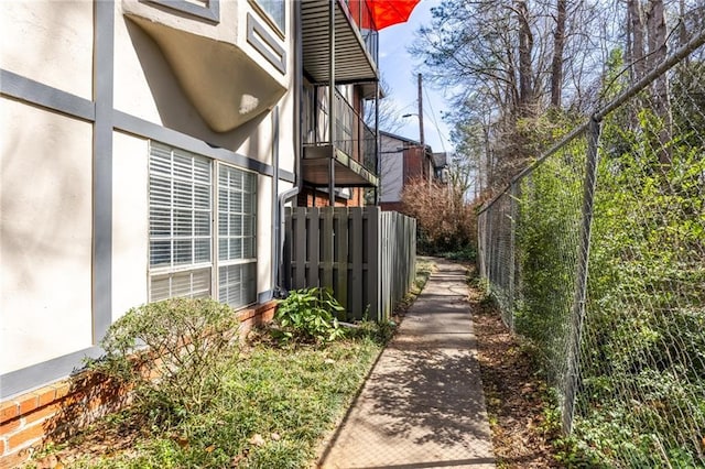 view of property exterior with fence and stucco siding