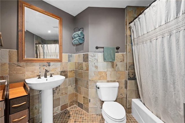 bathroom featuring sink, tile walls, tile patterned floors, and toilet