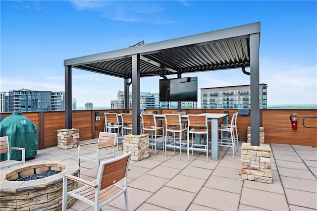 view of patio / terrace featuring exterior bar and a fire pit