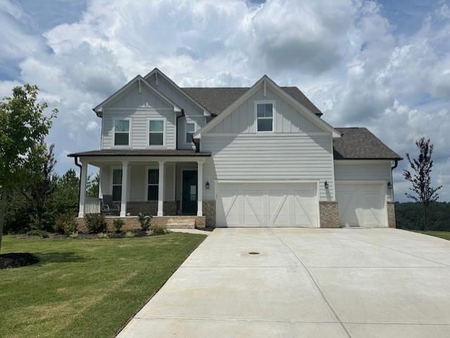 craftsman-style house with a front yard, covered porch, and a garage