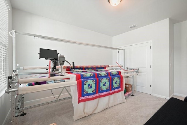 bedroom with light carpet and a closet