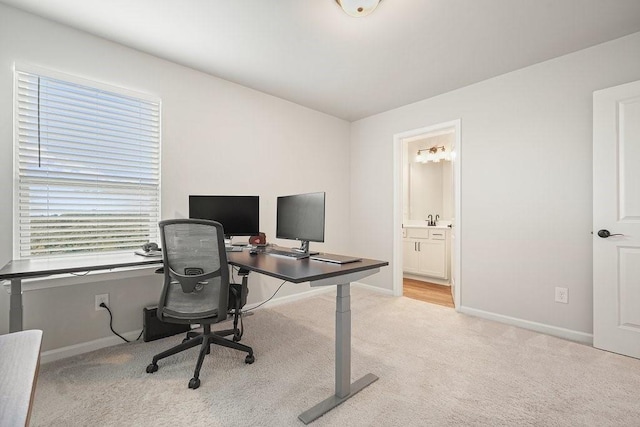 office featuring sink and light colored carpet