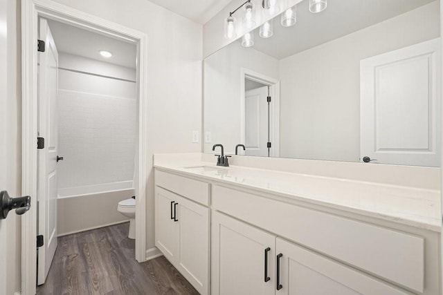 full bathroom featuring vanity, bathtub / shower combination, toilet, and hardwood / wood-style floors