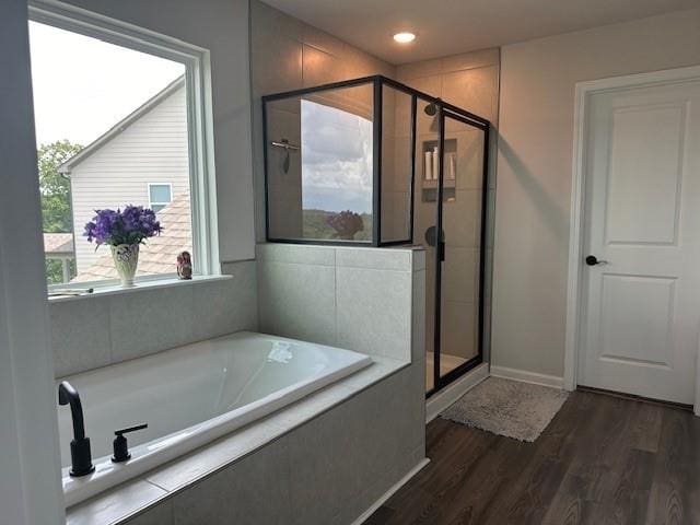 bathroom with wood-type flooring and plus walk in shower