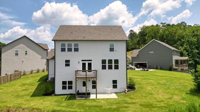 rear view of property with a patio area, a balcony, and a lawn