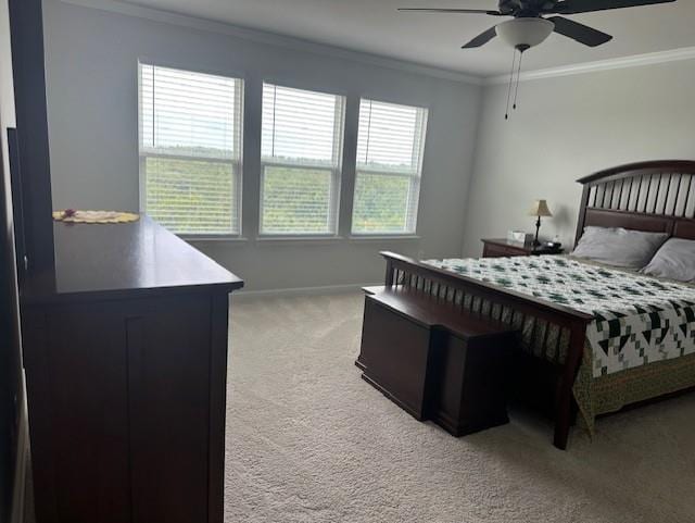 bedroom with light carpet, ornamental molding, and ceiling fan