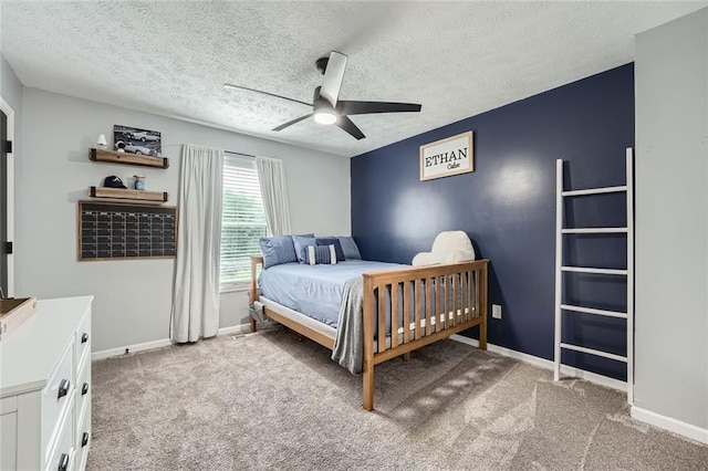 bedroom with baseboards, a textured ceiling, and light colored carpet