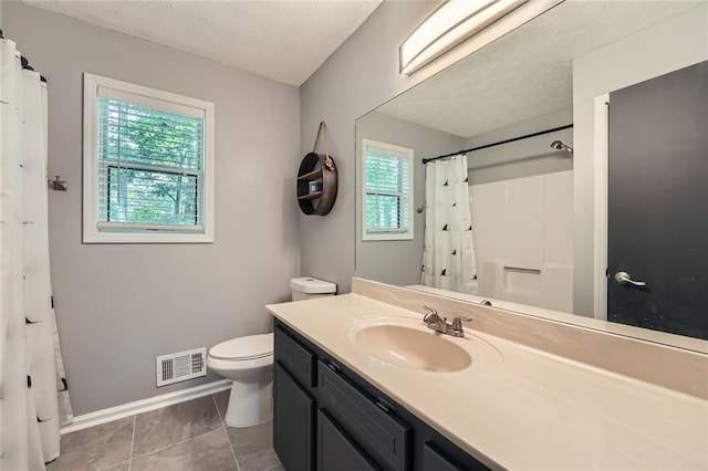 bathroom with visible vents, curtained shower, baseboards, vanity, and toilet