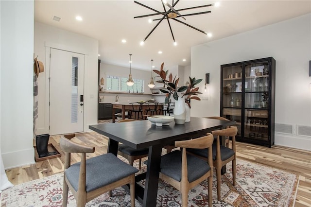 1168 Mado Loop, Chattahoochee Hills, GA 30268 - dining room featuring light wood finished floors, a chandelier, and recessed lighting