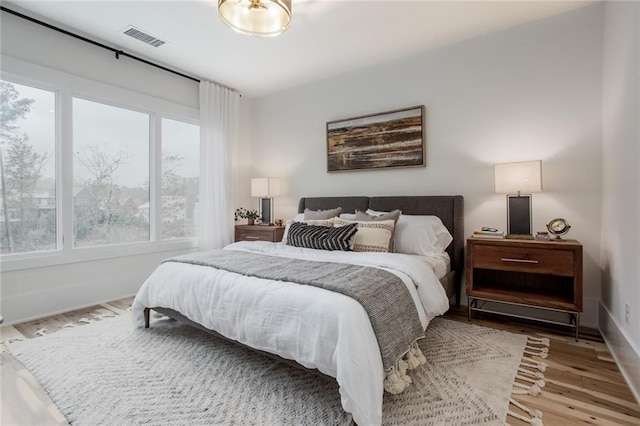 1168 Mado Loop, Chattahoochee Hills, GA 30268 - bedroom featuring multiple windows, wood finished floors, and baseboards