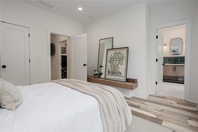 1168 Mado Loop, Chattahoochee Hills, GA 30268 - bedroom with light wood-style flooring, baseboards, recessed lighting, and ensuite bath