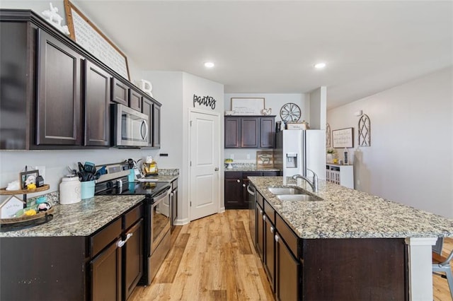 4770 Alford Commons, Cumming, GA 30028 - kitchen featuring stainless steel appliances, a sink, light wood-style flooring, dark brown cabinets, and recessed lighting