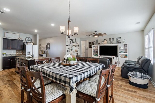 dining room with an inviting chandelier and light hardwood / wood-style floors