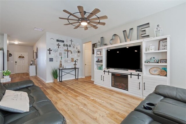 living room with ceiling fan and wood-type flooring