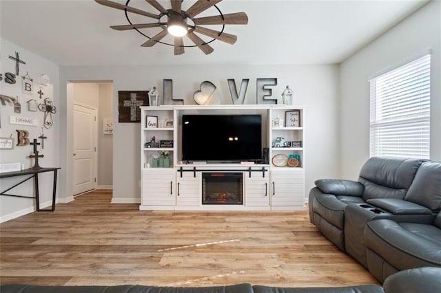 4770 Alford Commons, Cumming, GA 30028 - living room featuring a ceiling fan, wood finished floors, a lit fireplace, and baseboards