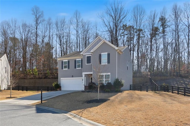 view of front facade with concrete driveway, fence, and a garage