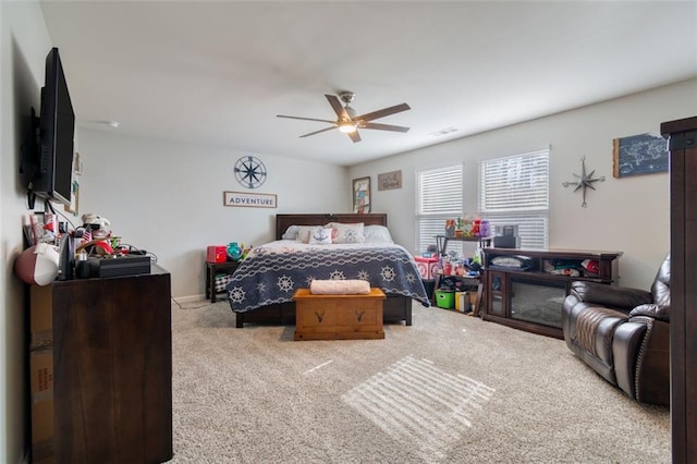 bedroom featuring light carpet and ceiling fan