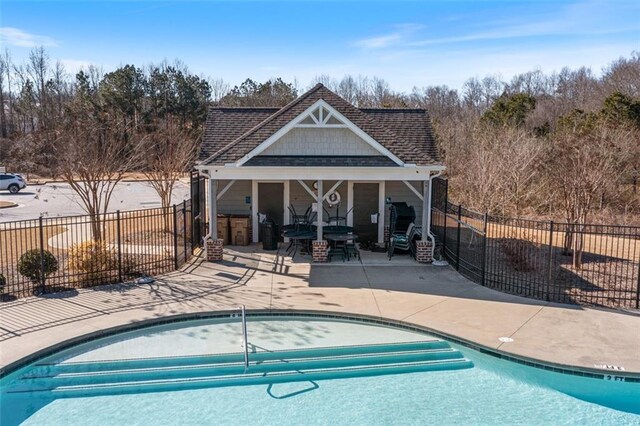 view of swimming pool with a patio area and an outdoor structure