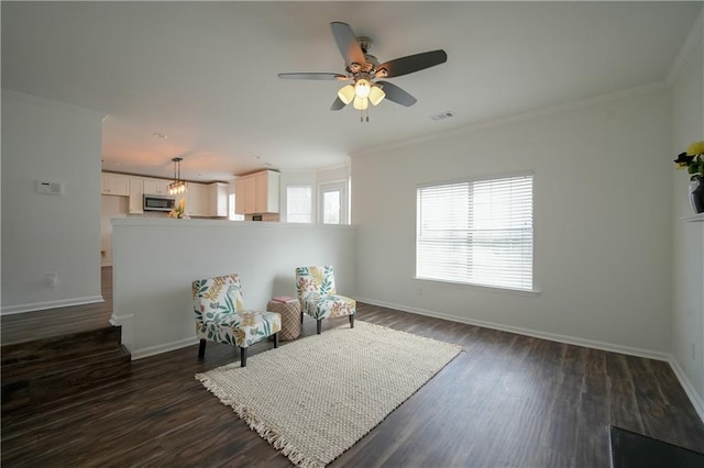 sitting room with crown molding, ceiling fan, and dark hardwood / wood-style flooring