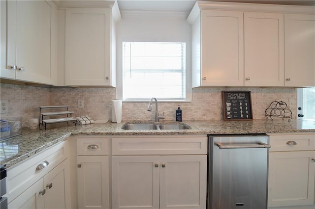 kitchen featuring tasteful backsplash, sink, and white cabinets