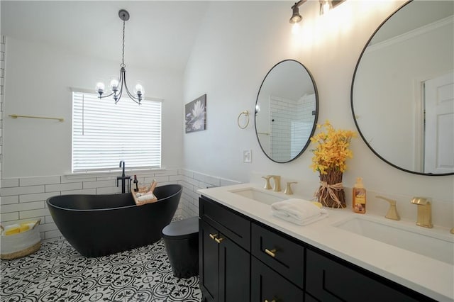 bathroom with a washtub, tile patterned flooring, tile walls, an inviting chandelier, and vanity