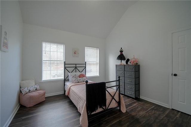 bedroom with lofted ceiling and dark hardwood / wood-style floors