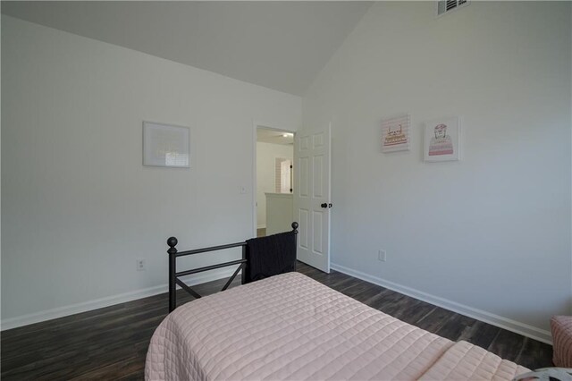 bedroom with dark hardwood / wood-style floors and vaulted ceiling