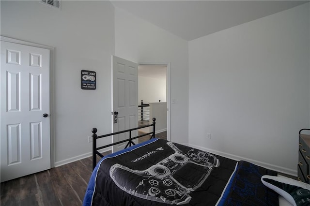 bedroom featuring vaulted ceiling and dark hardwood / wood-style floors