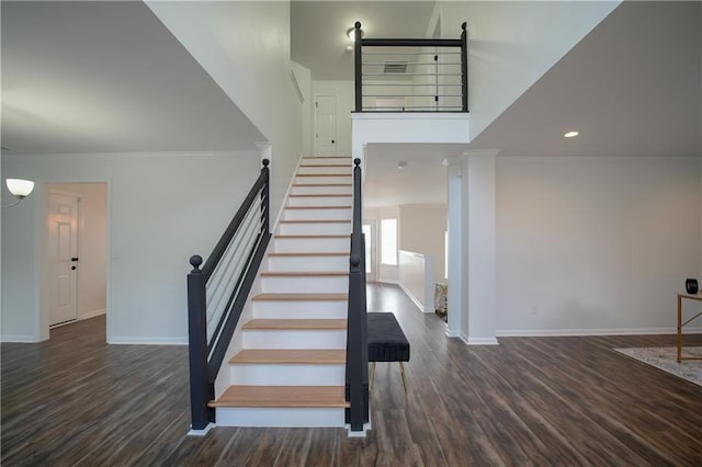 stairs with wood-type flooring and ornamental molding