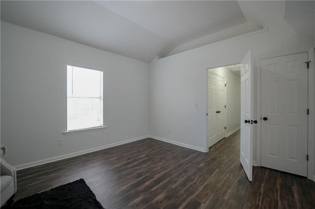 unfurnished room with lofted ceiling and dark hardwood / wood-style flooring