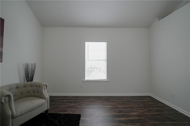 unfurnished room with dark hardwood / wood-style flooring and vaulted ceiling