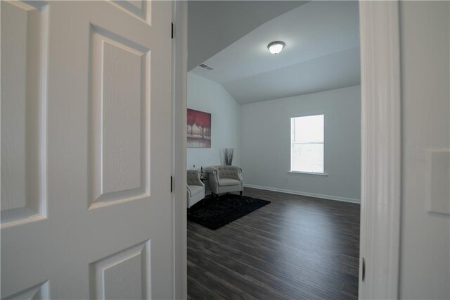 living area with lofted ceiling and dark hardwood / wood-style flooring