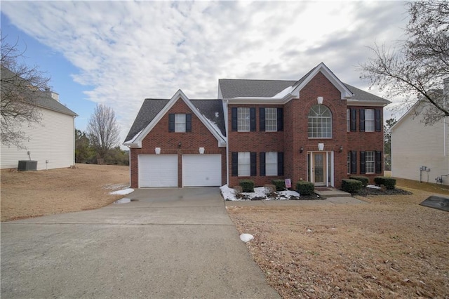 colonial home featuring a garage and central AC