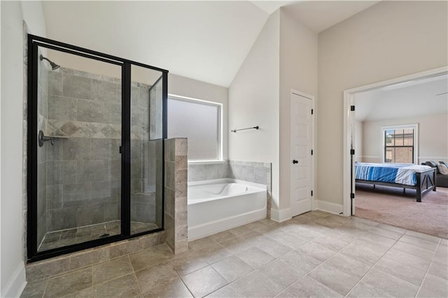 ensuite bathroom with a garden tub, connected bathroom, vaulted ceiling, and a shower stall