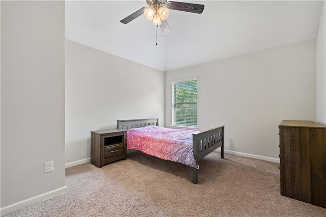 bedroom featuring light colored carpet, baseboards, ceiling fan, and lofted ceiling