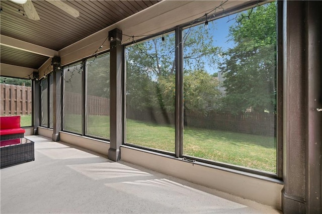 unfurnished sunroom with a ceiling fan