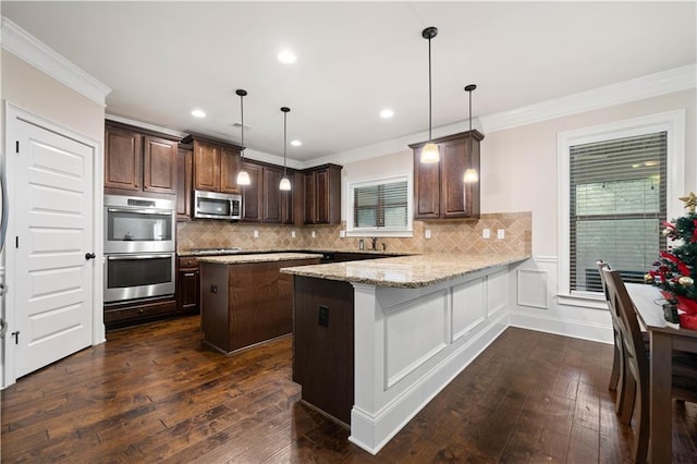 kitchen featuring dark wood-style flooring, stainless steel appliances, ornamental molding, and dark brown cabinets